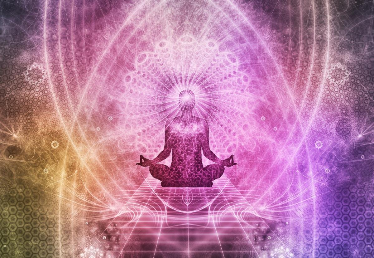 Image of a person meditating with pink and purple colors