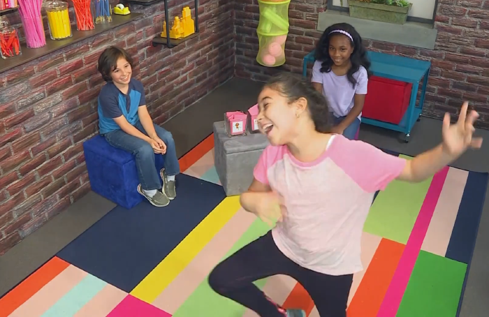 Three kids playing a game of charades