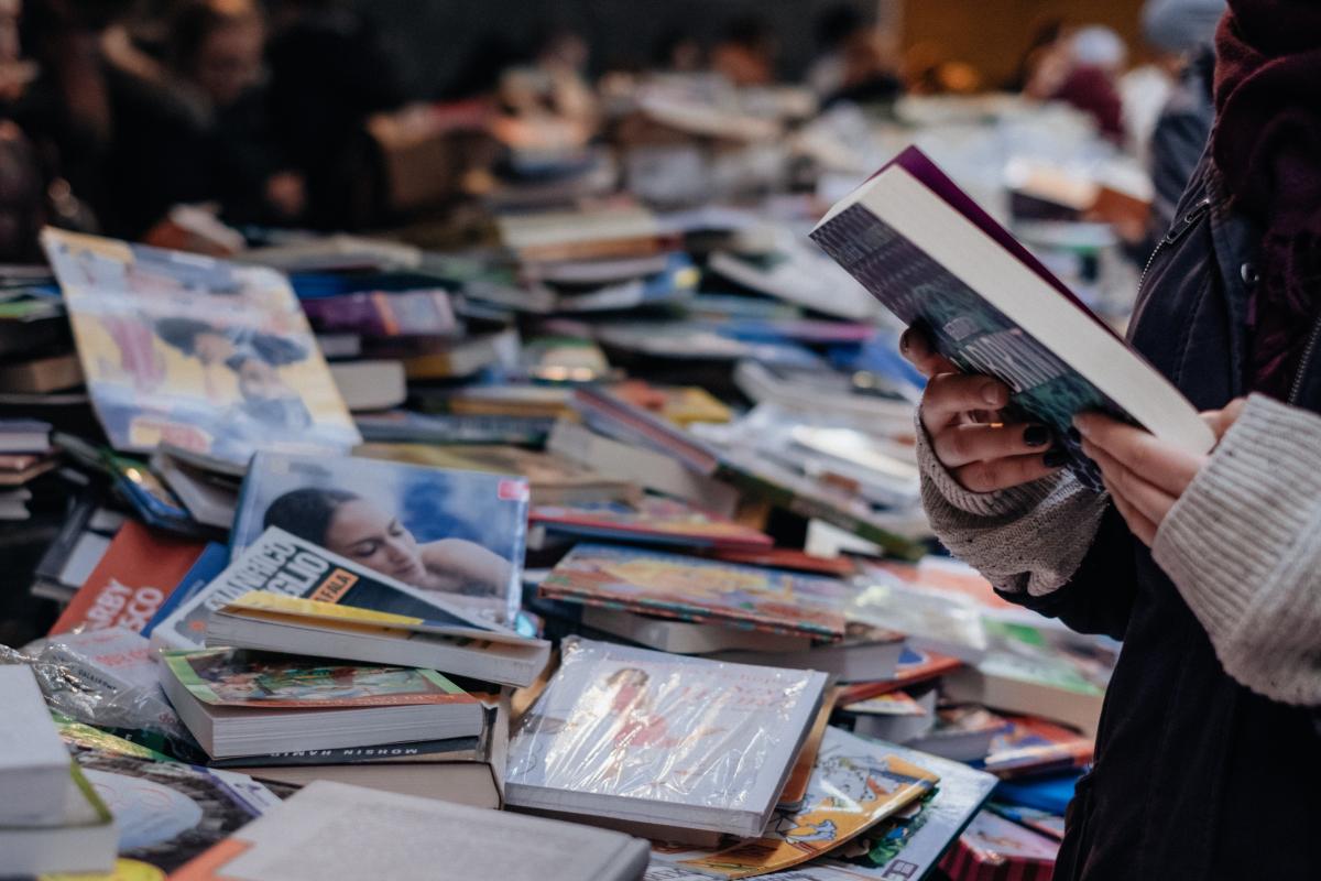 lady digging through book pile