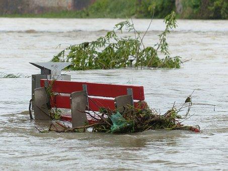 Flood water with a red red bench sticking though