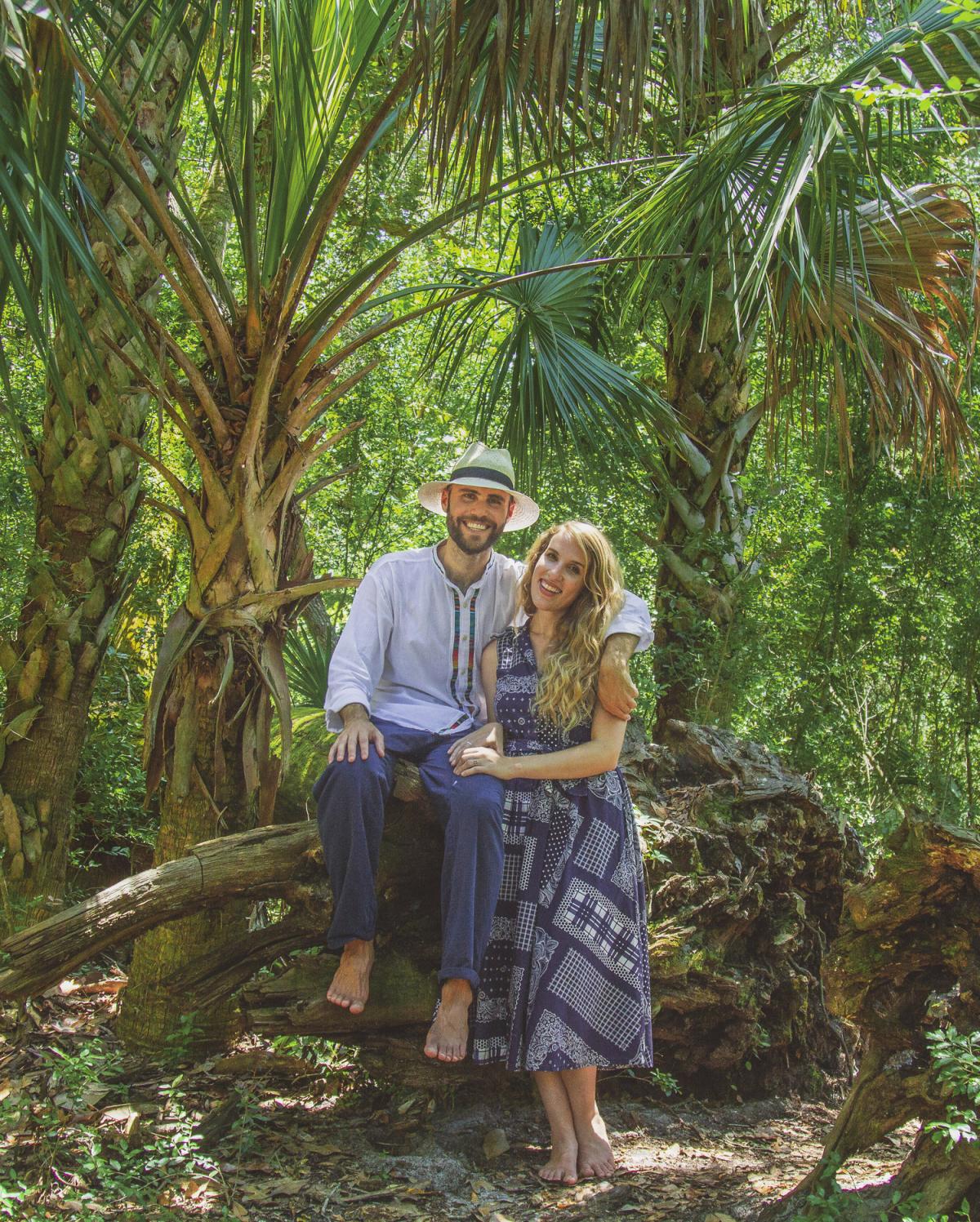 Man and woman in a jungle posing for a picture.