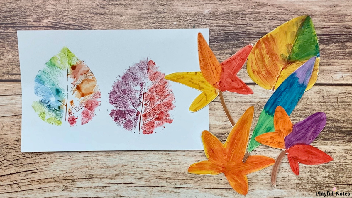 Leaves of different sizes and shapes painted and pressed on a white paper.