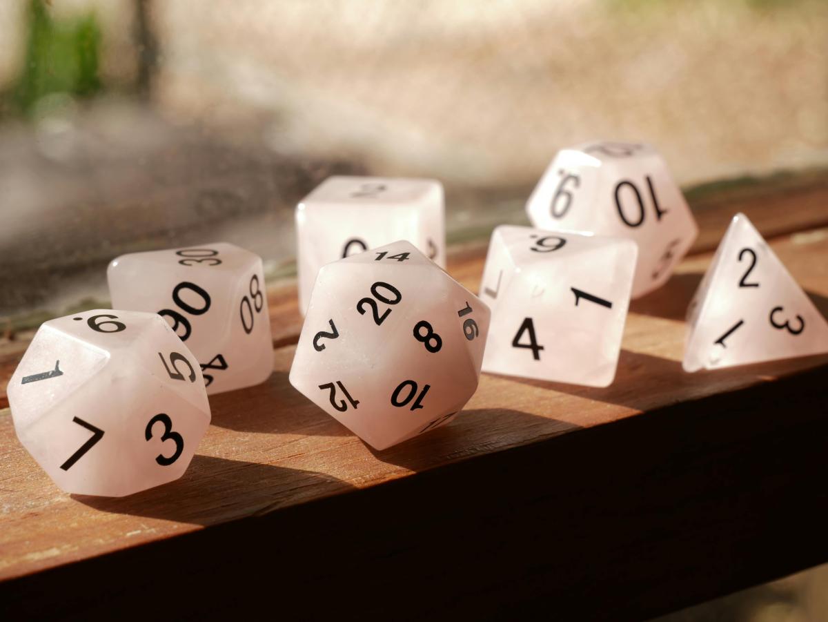 White D&D dice on a windowsill.