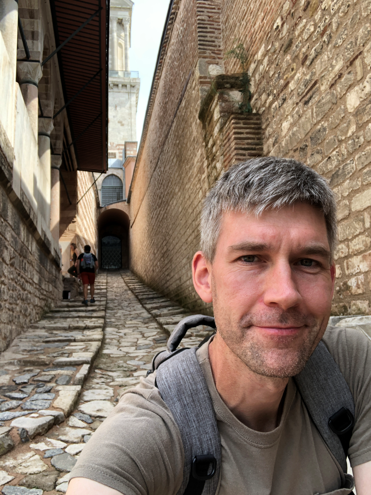 Author Sam Kean against an ancient brick building.