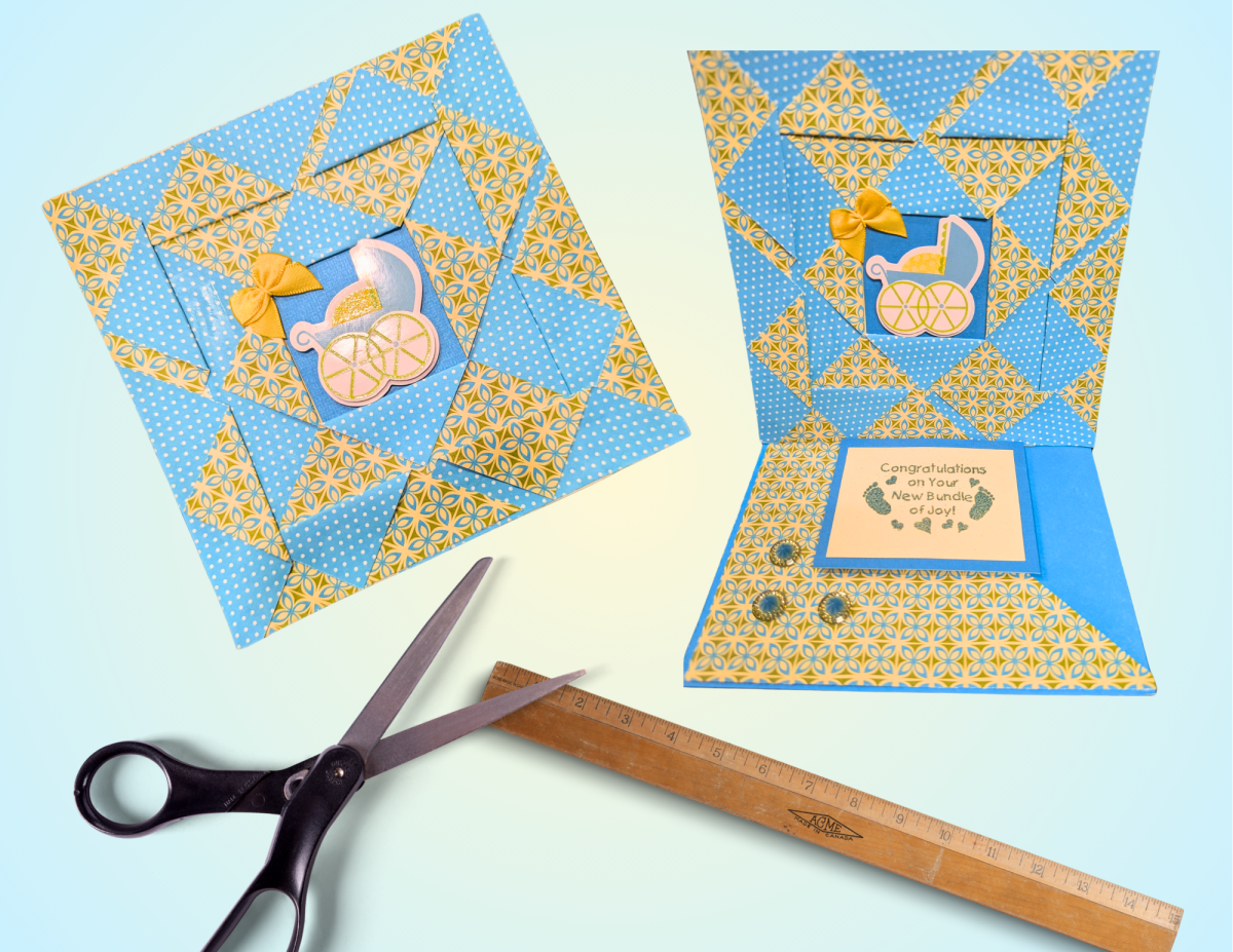 Handmade greeting card next to scissors and a ruler