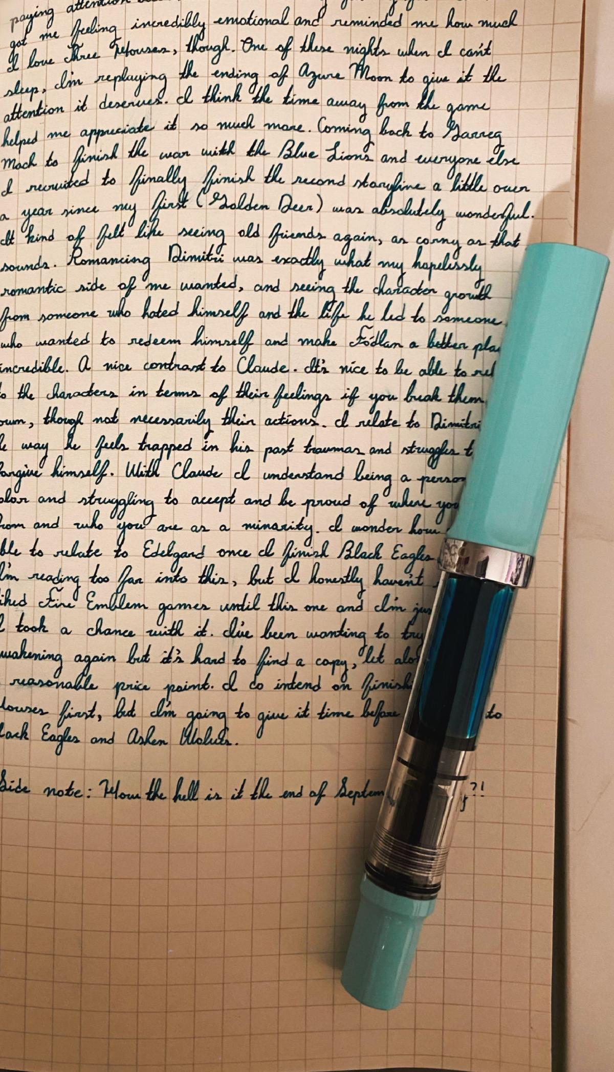 Fountain pen lays on top a cursive journal entry.