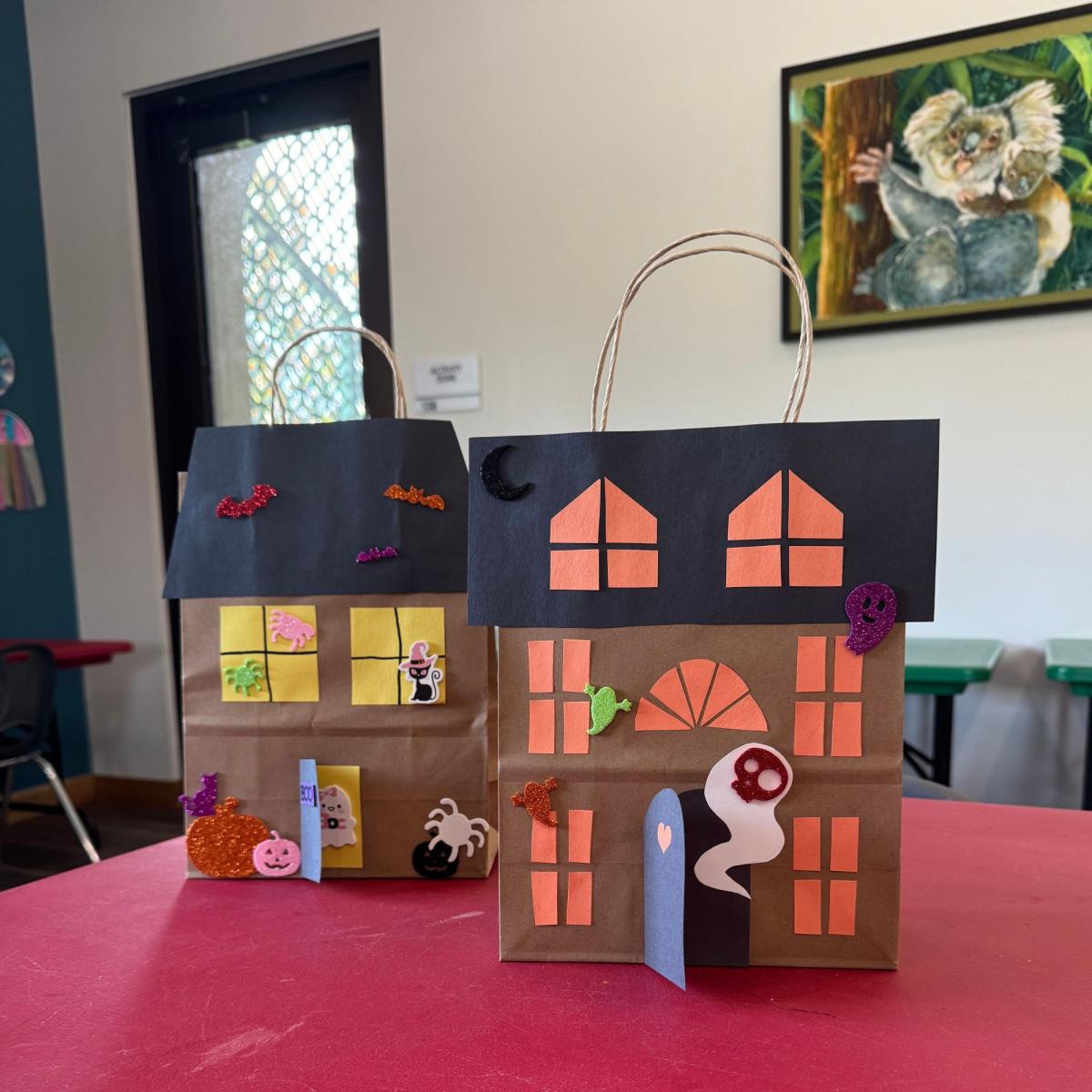 Picture of two paper bags decorated as haunted houses