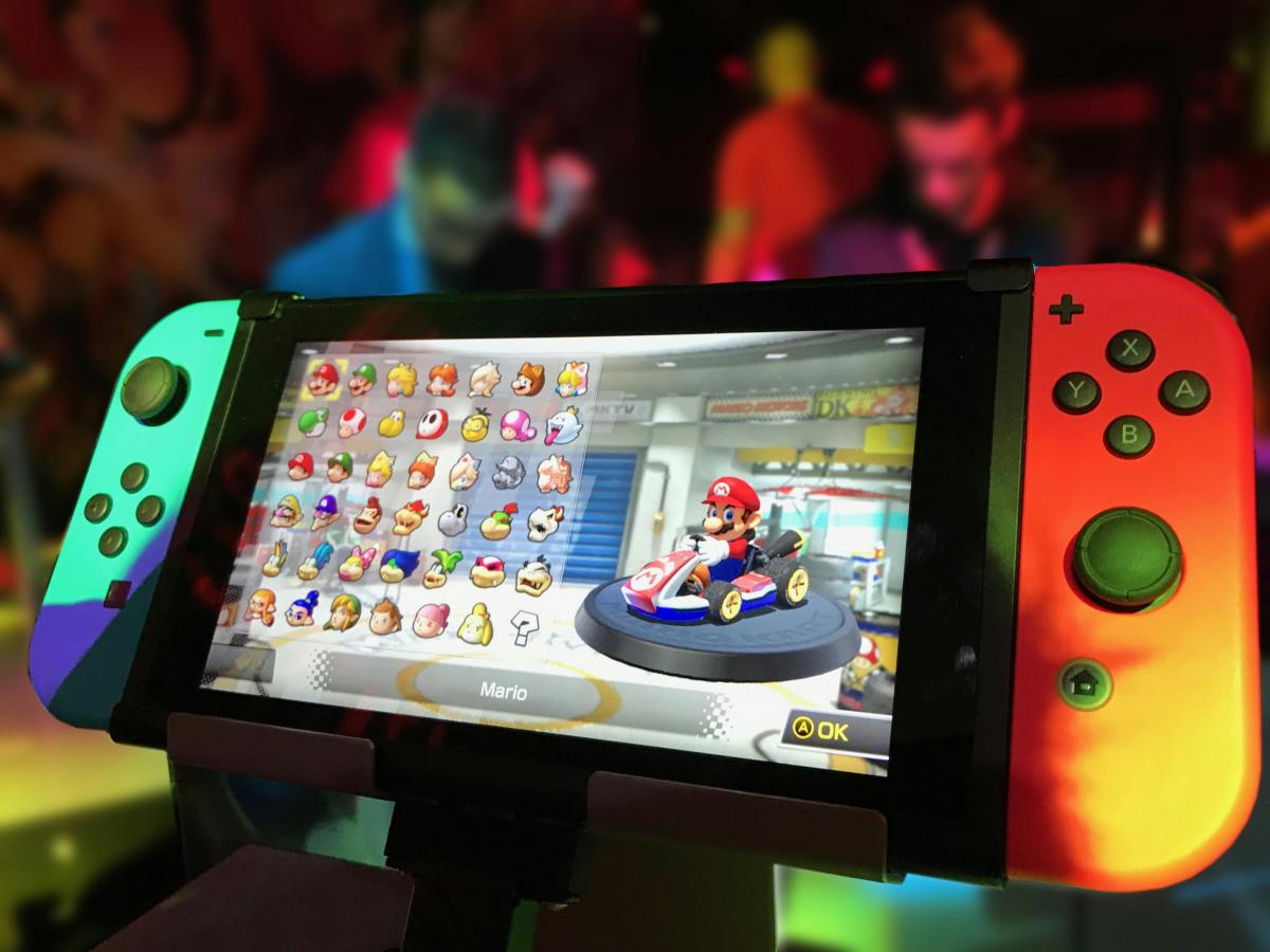 A Nintendo Switch with an image of the game, Mario Kart, on the screen