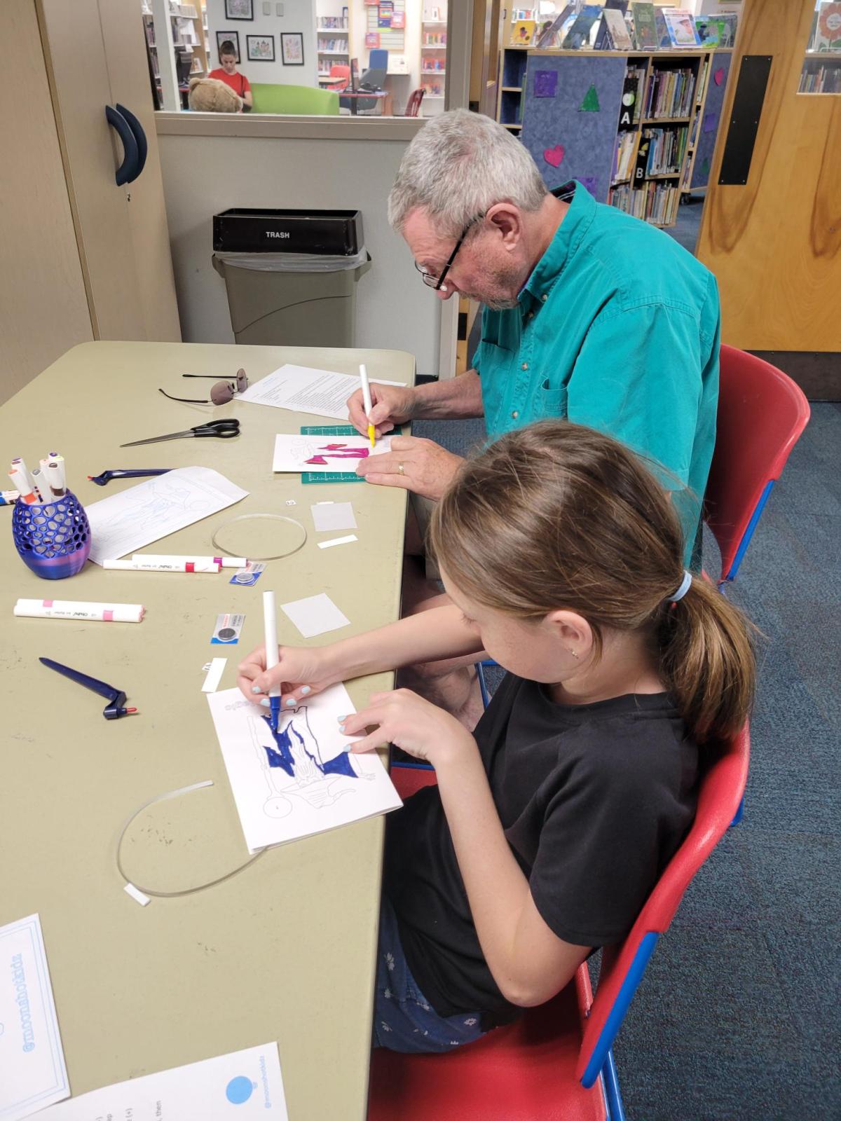 Patrons making paper circuit art.