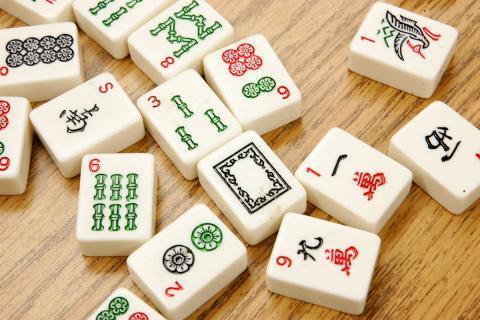 Mahjong tiles on a wooden table.